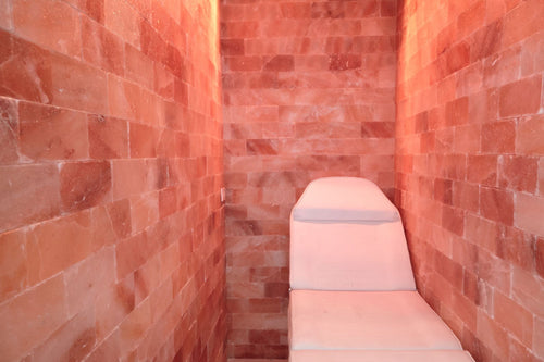 wellness chair in a room with red brick walls