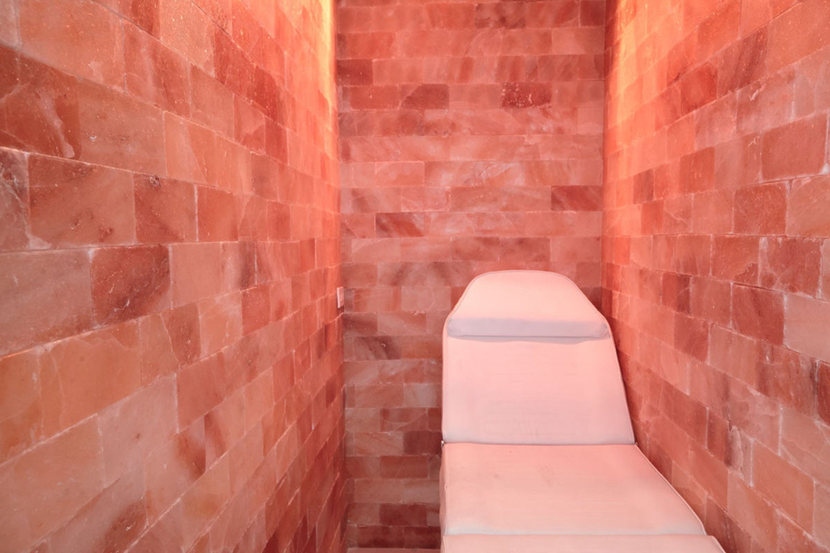 Salon chair in a room with red brick walls